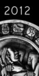 carved glyphs on a stone Mayan calendar with 2012 text