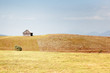 Photo: Grass field, old cottage and blue sky Grass field, old cottage and blue sky