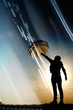 Man with umbrela under rays