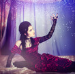 Photo: A portrait of the girl in Gothic style on a beautiful bed A portrait of the girl in Gothic style on a beautiful bed