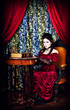 Photo: A portrait of the girl in Gothic style with the book in hands A portrait of the girl in Gothic style with the book in hands