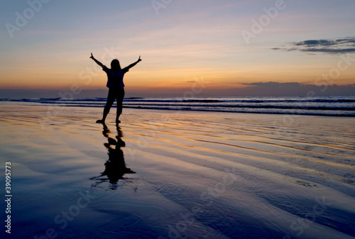 Photo: silhouette of a woman raising her two hands silhouette of a woman raising her two hands