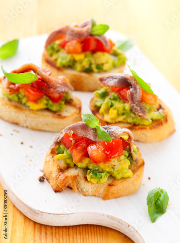 Photo: crostini with avocado,tomato and anchovy crostini with avocado,tomato and anchovy