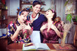 Portrait of three cheerful housewives