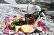 Red wine, cheese and grapes served at a picnic