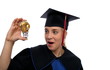 Beautiful girl in the graduation cap and glass bulb with coins Beautiful girl in the graduation cap and glass bulb with coins