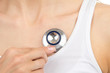 Doctor woman auscultating young patient