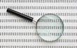 magnifying glass and document with figures