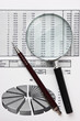 magnifying glass and working paper