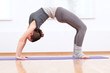 Woman doing stretching yoga exercise at sport gym