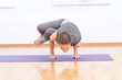 Woman doing stretching yoga exercise at sport gym