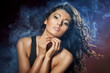 Portrait of young seductive woman in the blue smoke on the black