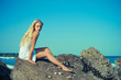 Beautiful woman on a rocky seashore