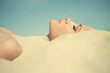 Beautiful lady buried in the sand
