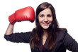 Businesswoman hitting herself with boxing gloves