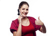 Young woman talking on the phone showing hand ok sign