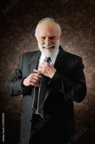 Photo: a man fixes the tie a man fixes the tie