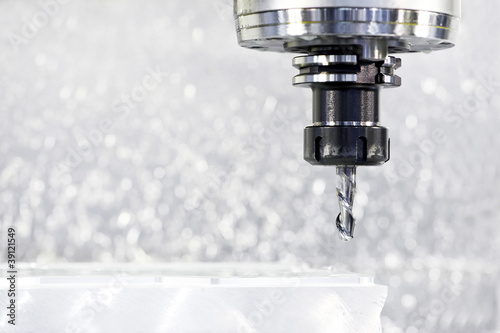 Photo: Close-up process of metal machining by mill Close-up process of metal machining by mill