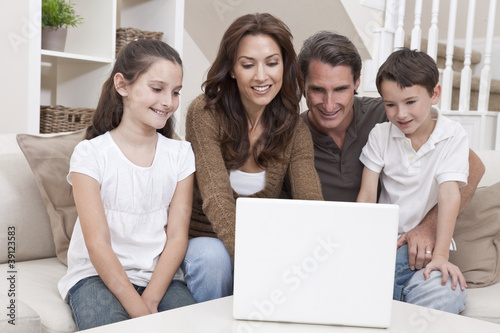 Photo: Happy Family Using Laptop Computer on Sofa at Home Happy Family Using Laptop Computer on Sofa at Home