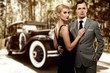 Retro couple against old car.