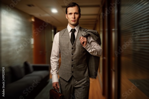 Photo: Man with a briefcase in a hotel hallway. Man with a briefcase in a hotel hallway.