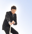 A young and handsome businessman pulling the rope