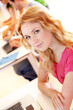 Beautiful blond girl working on laptop computer