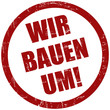 Grunge Stempel rot WIR BAUEN UM!