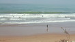 Surfers beach, pan shot, slow motion