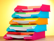bright paper trays on wooden table on yellow background bright paper trays on wooden table on yellow background
