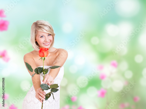 Photo: junge blonde Frau im weißen Kleid mit Rose junge blonde Frau im weißen Kleid mit Rose