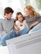 Family watching movie on television