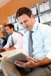 Portrait of business manager using electronic tablet