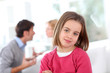 Portrait of upset child with parentt's fighting