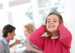 Photo: Child hiding her ears from parent's fight Child hiding her ears from parent's fight