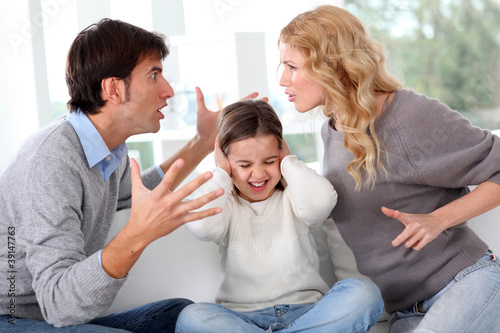 Photo: Couple fighting in front of child Couple fighting in front of child
