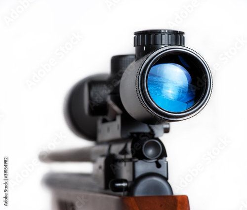 Photo: Closeup of a sniper rifle telescope glass lens isolated Closeup of a sniper rifle telescope glass lens isolated