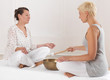 Zwei junge Frauen bei einer Klangschalenmassage