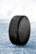 black hockey puck on ice rink