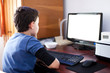 Photo: Boy reading on computer screen Boy reading on computer screen