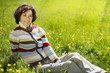 Relaxing woman on the green meadow