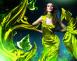 sensual beautiful woman in green fabric and leaves