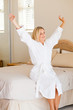 pretty young woman in pajamas just wake up and stretch on bed