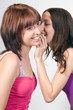 girlfriends whispering and smiling