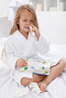 Little girl with a bad case of influenza using nasal spray