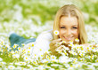 Beautiful girl enjoying daisy field