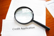 magnifying glass on a blank credit application