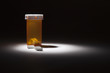 Foto: Medicine Bottle and Pills Under Spot Light Medicine Bottle and Pills Under Spot Light