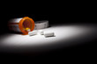 Foto: Medicine Bottle and Pills Under Spot Light Medicine Bottle and Pills Under Spot Light