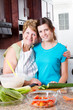 happy grandma and teen granddaughter portrait in kitchen